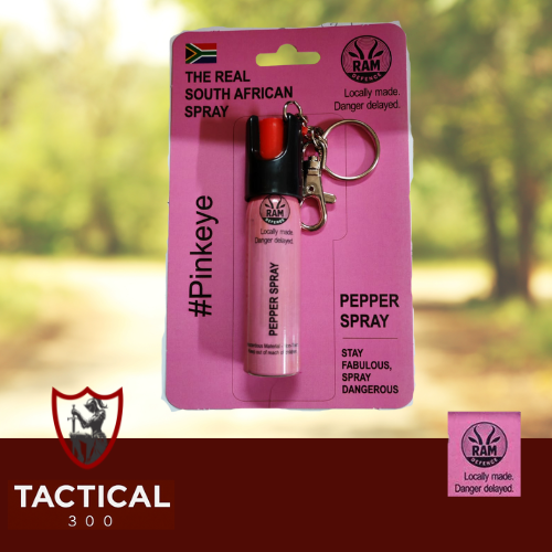 Compact 20 ml RAM Defense Pepper Stream canister (pink / blue) with key-chain loop — handheld OC pepper spray for self-defence, shown on plain background.