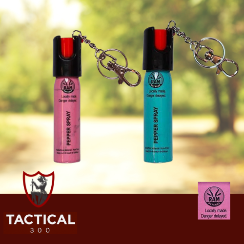 Compact 20 ml RAM Defense Pepper Stream canister (pink / blue) with key-chain loop — handheld OC pepper spray for self-defence, shown on plain background.