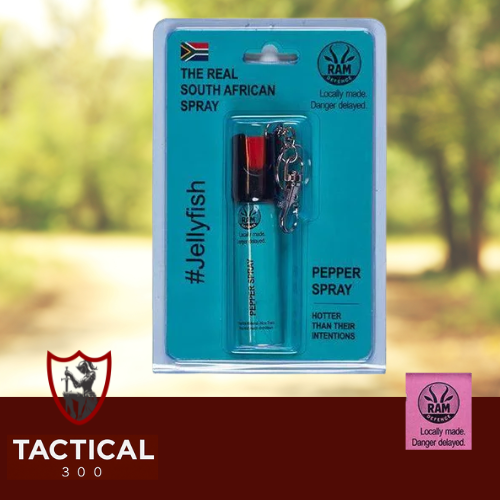 Compact 20 ml RAM Defense Pepper Stream canister (pink / blue) with key-chain loop — handheld OC pepper spray for self-defence, shown on plain background.